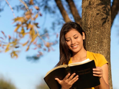 happy woman reading the word of God