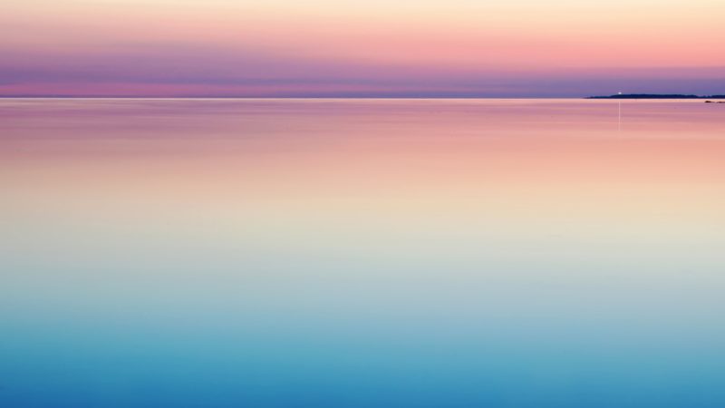 blue and pink sunset on calm lake