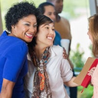 multicultural group of people smiling and enjoying church