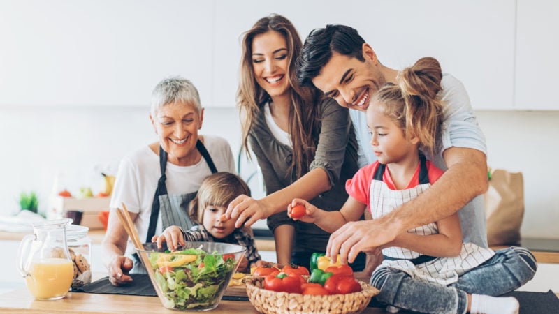 family having fun cooking a healthy meal together in the kitchen