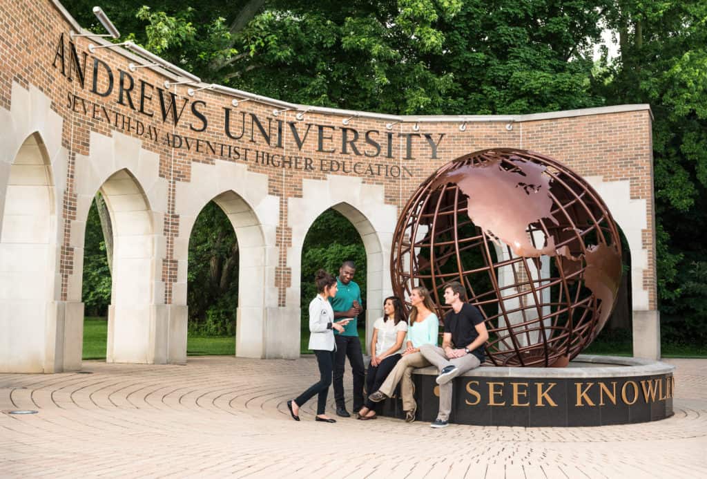 Iconic bronze globe statue and brick arches at Andrews University in Michigan