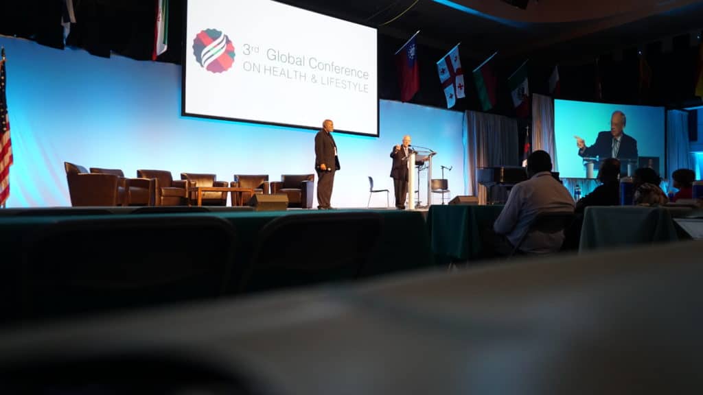 Health and Lifestyle Conference stagefront with speakers presenting at the Adventist conference on Health and Lifestyle
