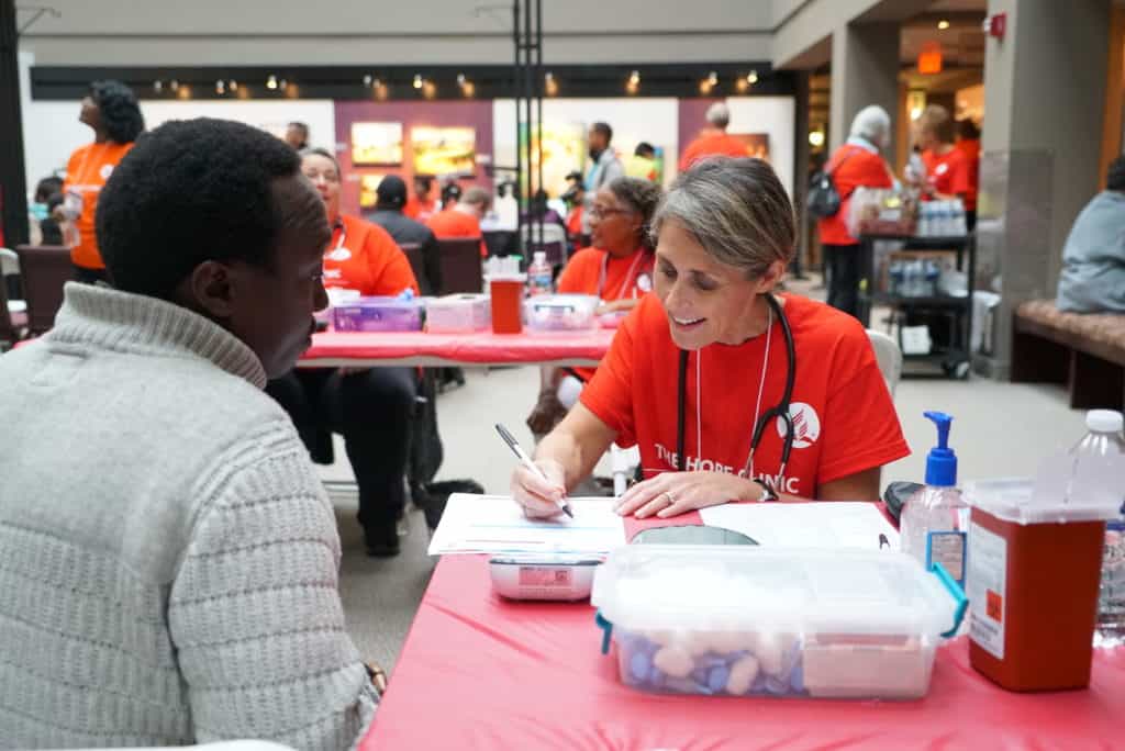 medical volunteer taking patient information at health clinic