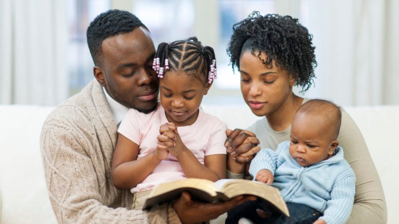 Family praying during family worship