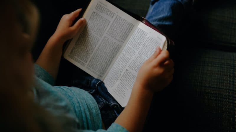 Little girl reading the Bible