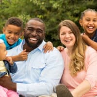 interracial family smiling and having a great time bonding together