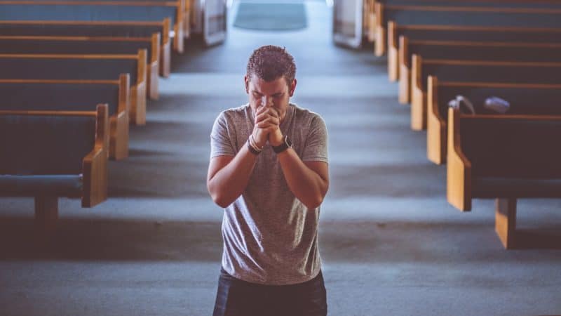 man kneeling at front of church asking God for a more vibrant prayer life