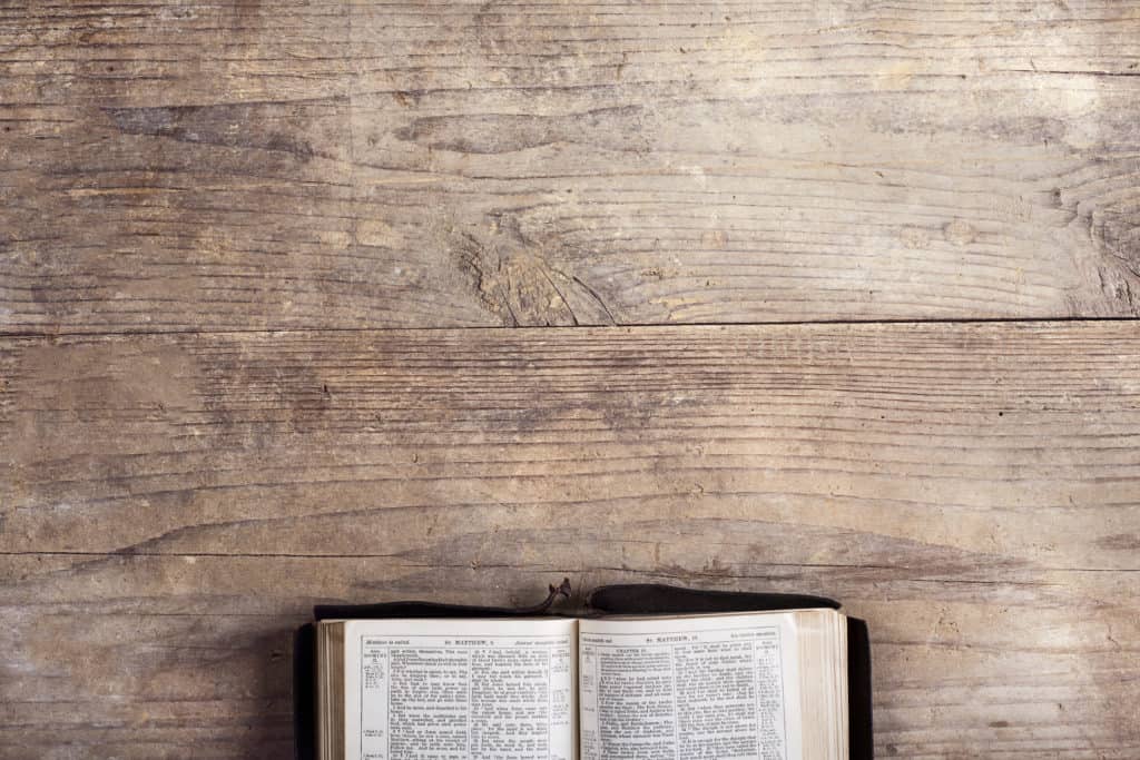 A Bible opened on a wood desk, to Matthew studying how Jesus celebrated the Sabbath.