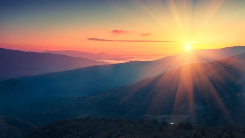 Panoramic view of  colorful sunrise in mountains. Filtered image:cross processed vintage effect.