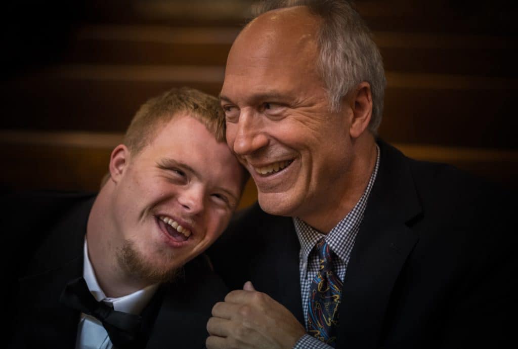 Happy father and his son with Down syndrome at church