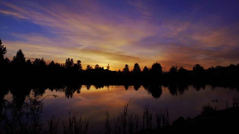 Sunset over a lake, representing the time God set aside for spending Sabbath with Him.