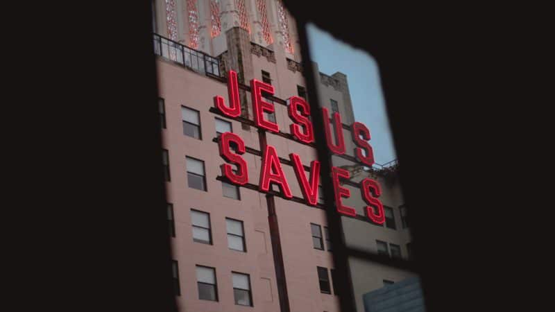 A sign on a building that says 'Jesus Saves'