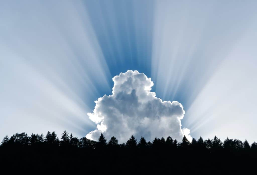 Clouds with the sun shining behind casting rays of light.