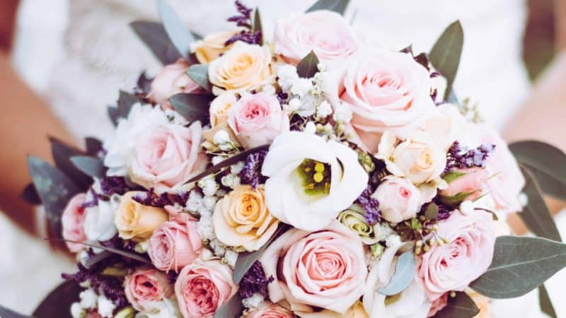 A bride holding her bouquet. 