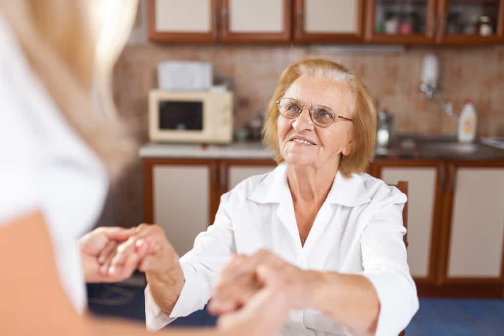 A woman providing care and support for elderly woman