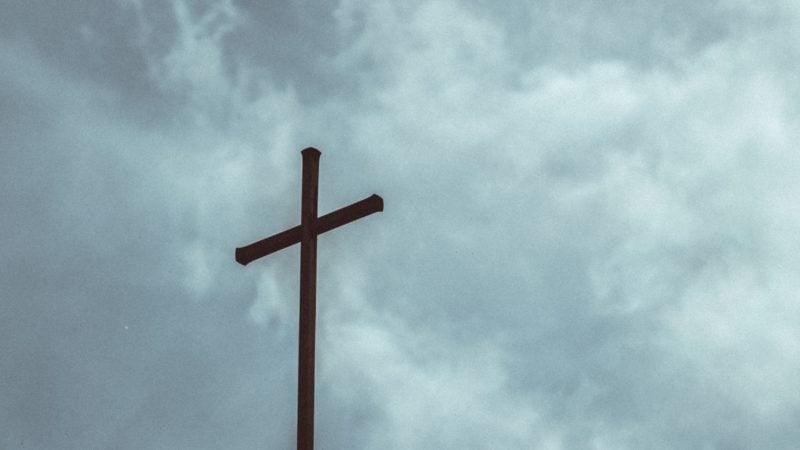 The cross against a cloudy sky as we study about the death of Jesus on the Cross of Calvary for our sins