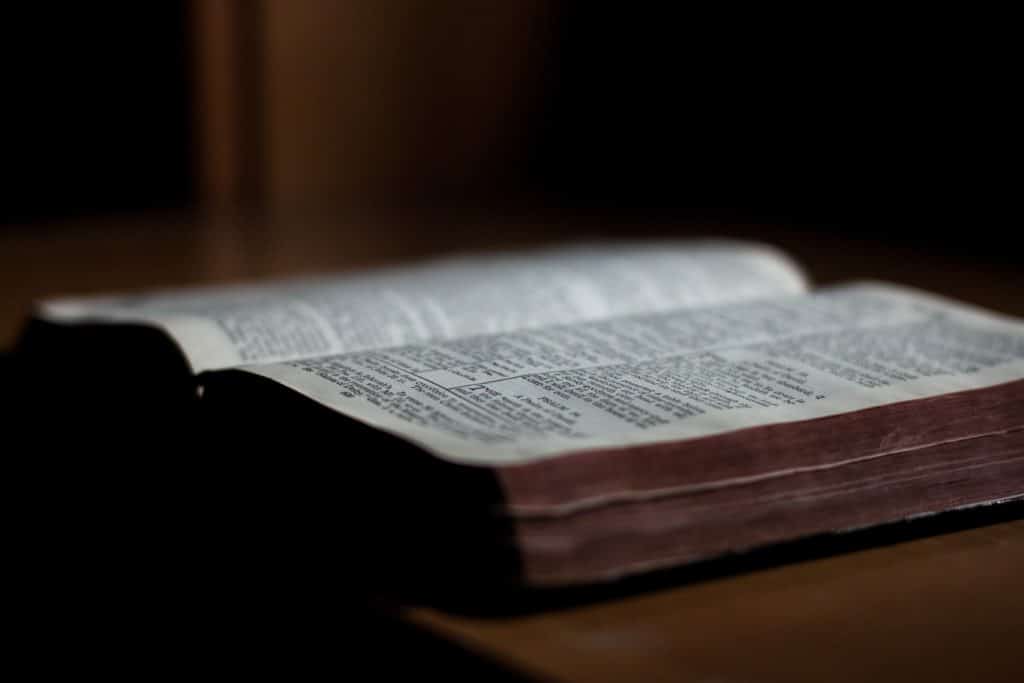 Close-up of an open Bible on a table.