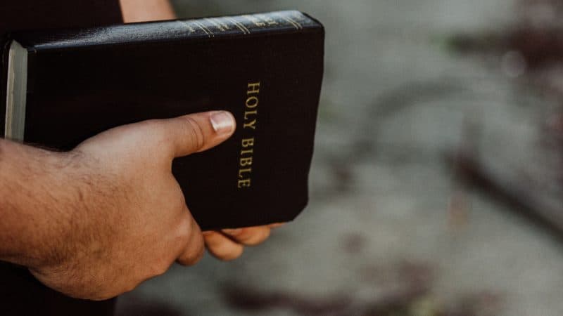 Close-up of a mans hands holding the Bible.