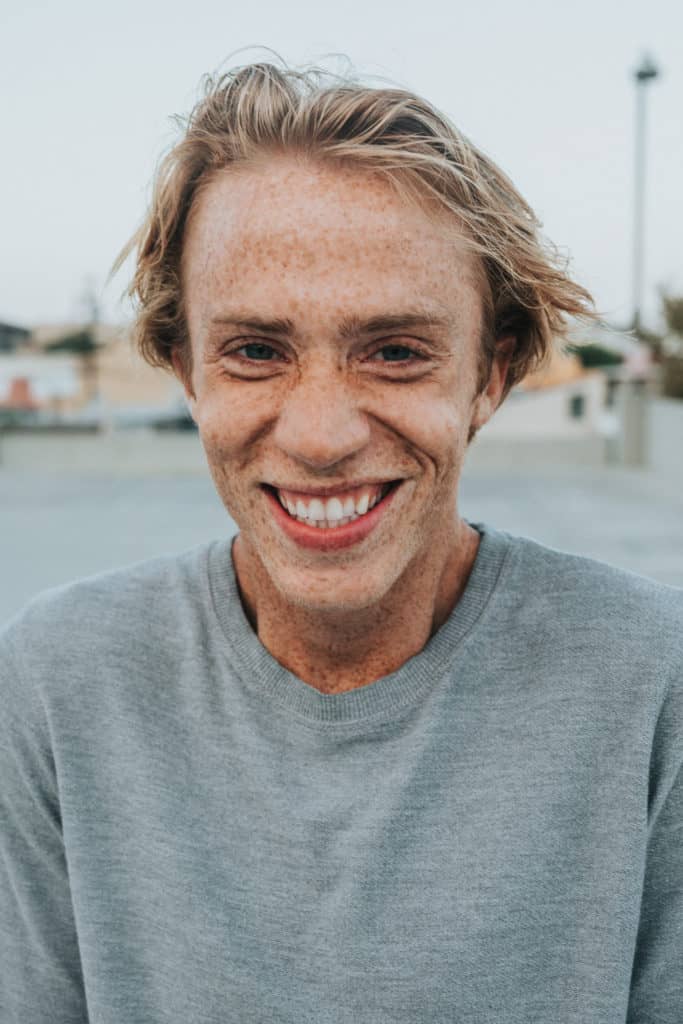 Young man smiling in to the camera.