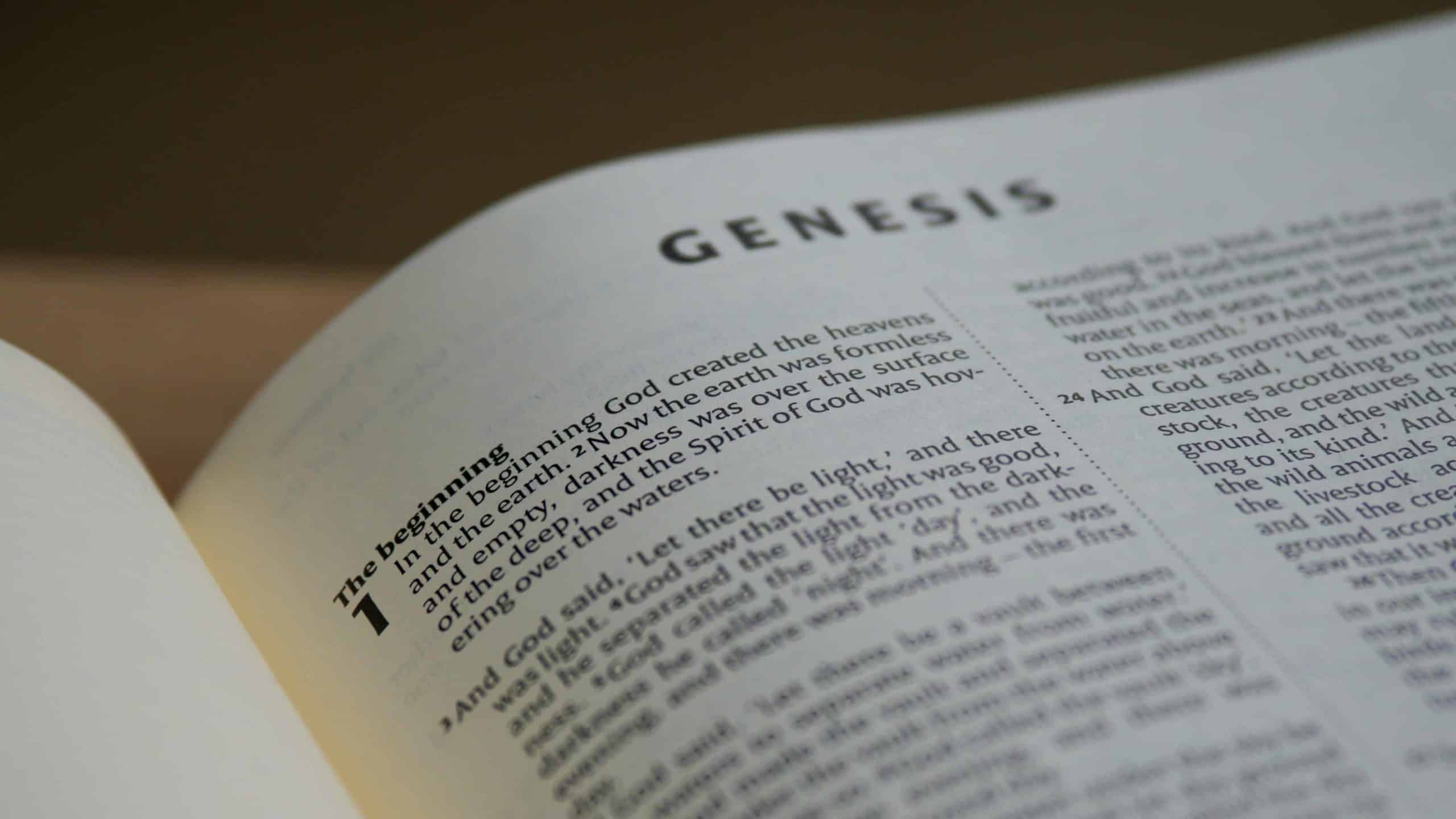 The Bible opened to the first chapter of Genesis.