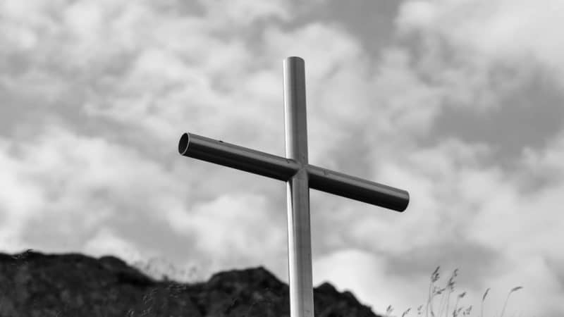 A black and white picture of a cross