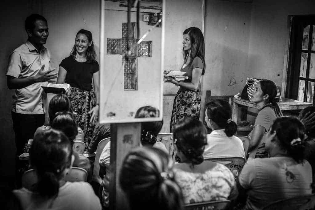 Black and white photo of people at church.