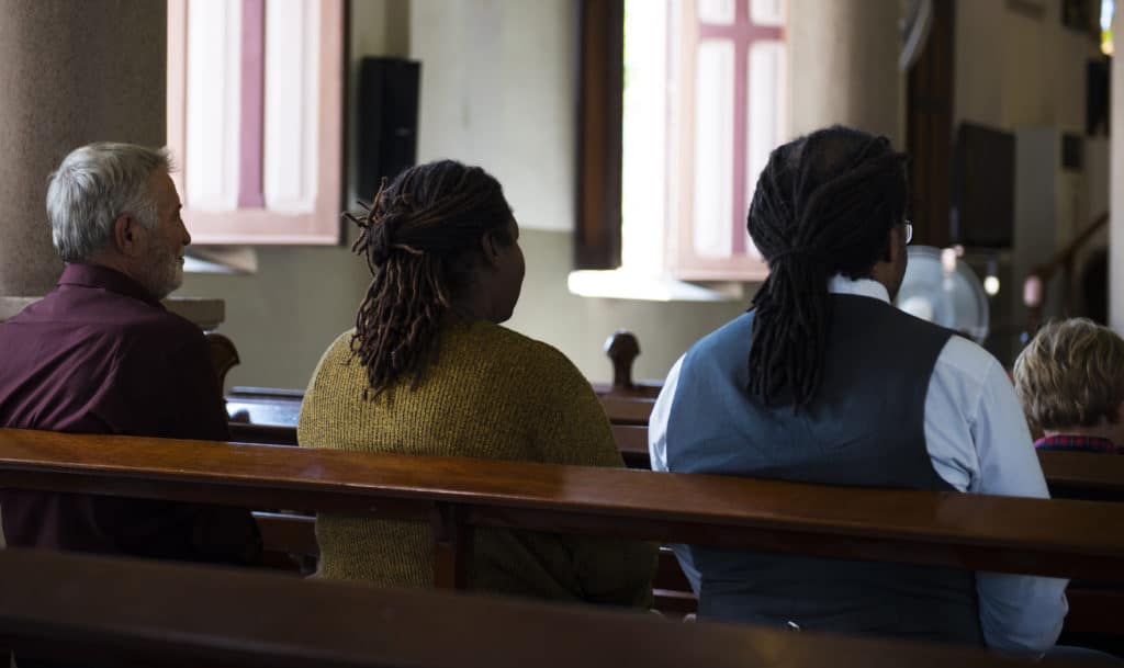 People sitting in pews at church.