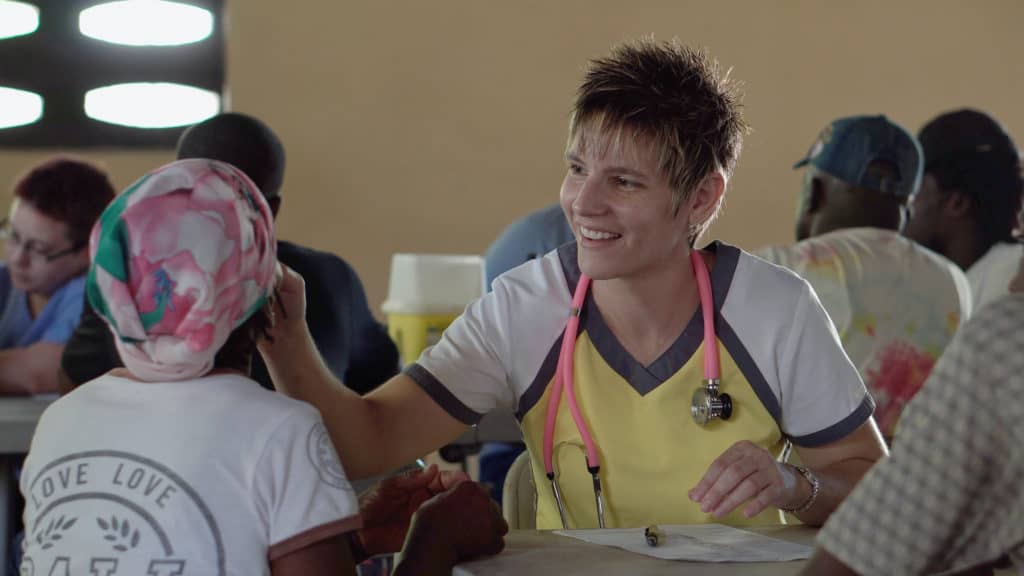 A doctor helping someone at a health clinic.