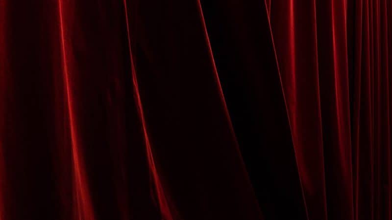 A close-up of a thick red curtain.