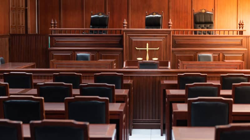 Red wood table and red chair in the justice court