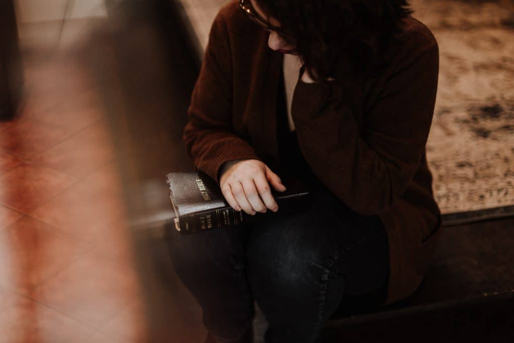 A woman sitting with her Bible.