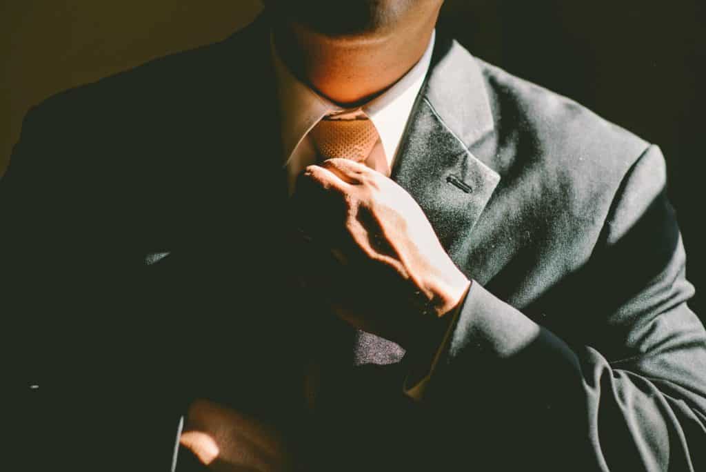 A man straightening his tie.