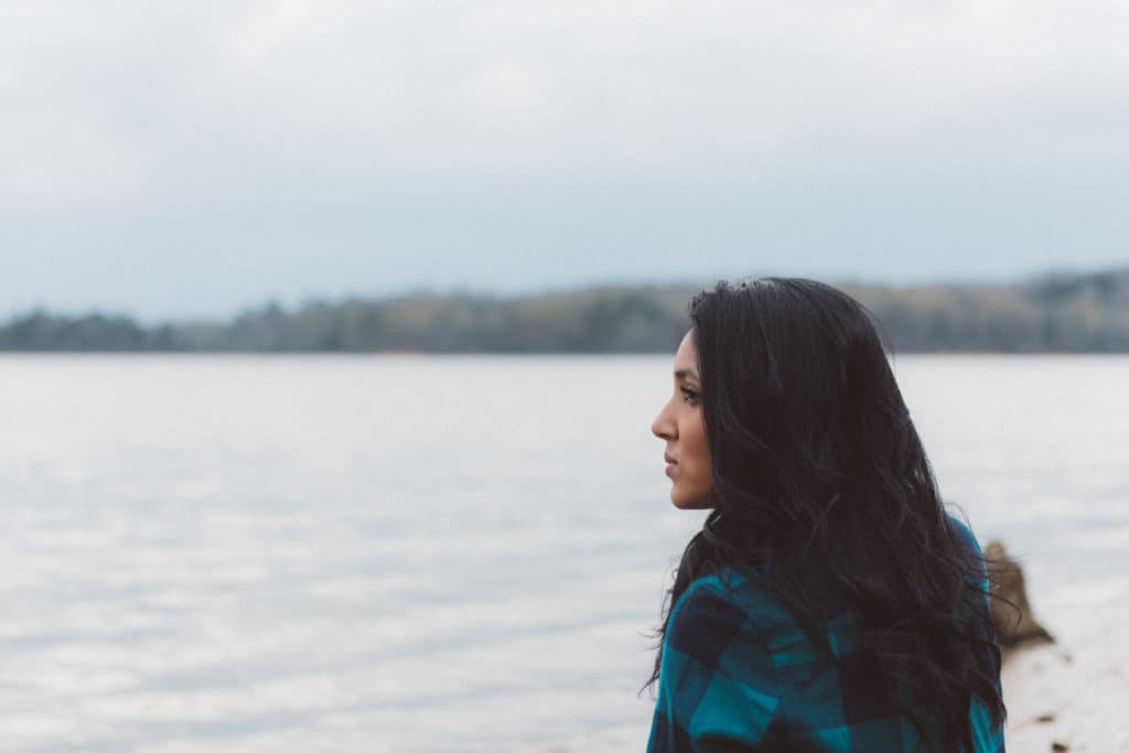 A woman looking out over a body of water.