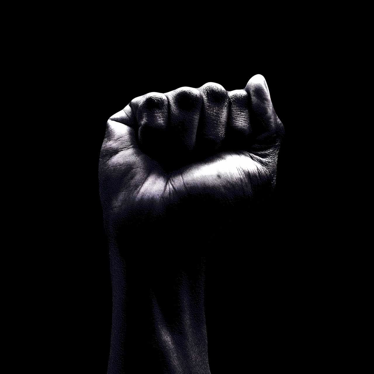 A fist in front of a black background.