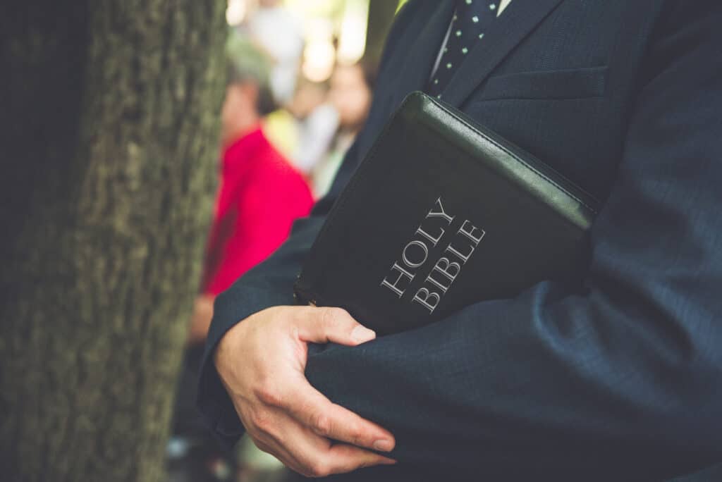 Man holding Bible.