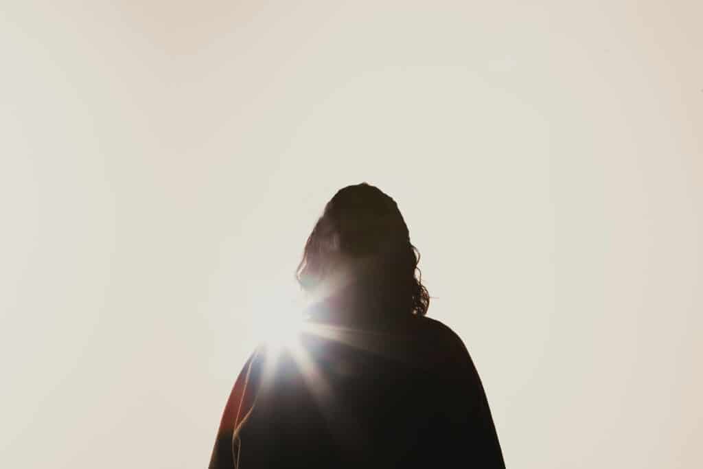 Person silhouetted by the sun.