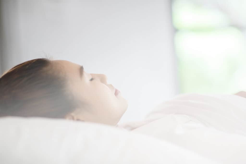 Woman sleeping on bed.