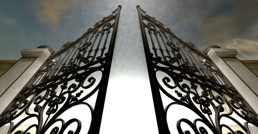 Dramatic view of tall black gates from the base.