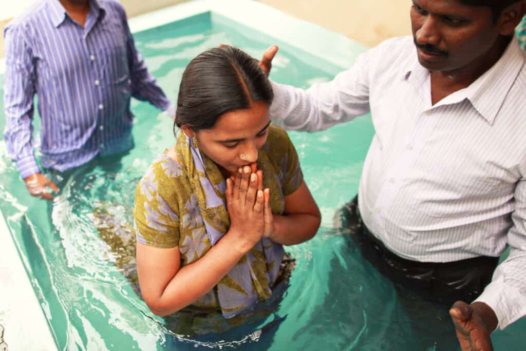 Woman praying before being baptized. 