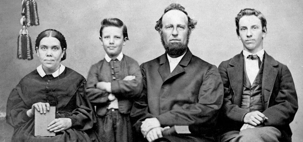 A black and white photo of Ellen White with her husband James, and 2 of their children. 