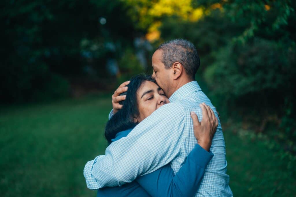 Man and woman hugging each other tightly. 