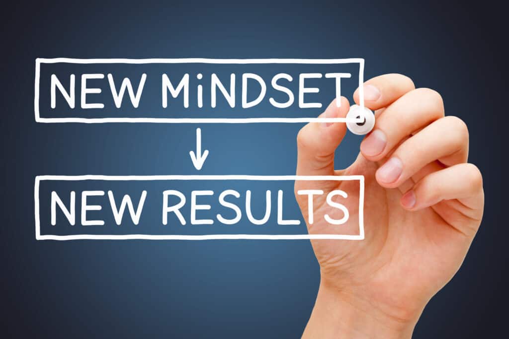 Nurse's hand writing a diagram of how a new mindset will provide new healthy results.
