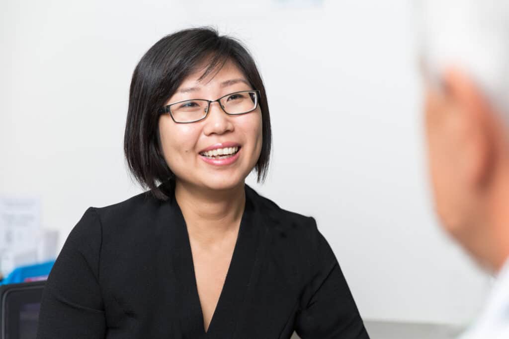 Smiling asian woman talking to her father, in a healthy relationship.