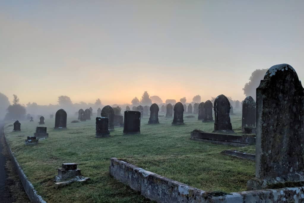 An old graveyard full of tombstones, where those righteous will be resurrected at Jesus' return.