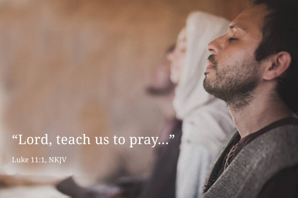 Man praying next to his family, asking for wisdom.