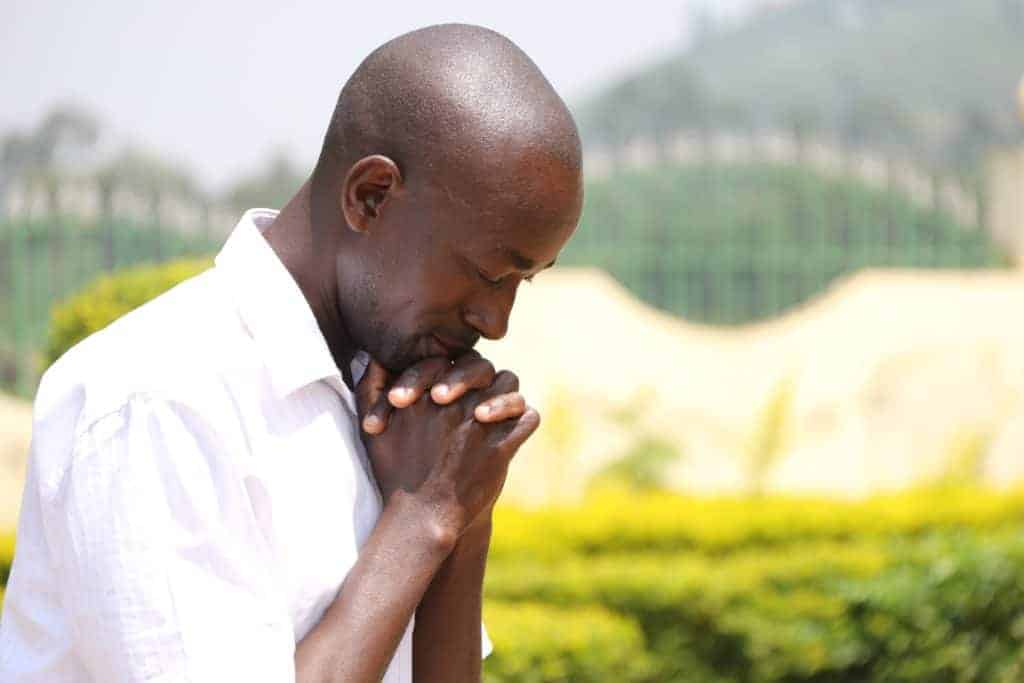 A man praying in communication with God outside.