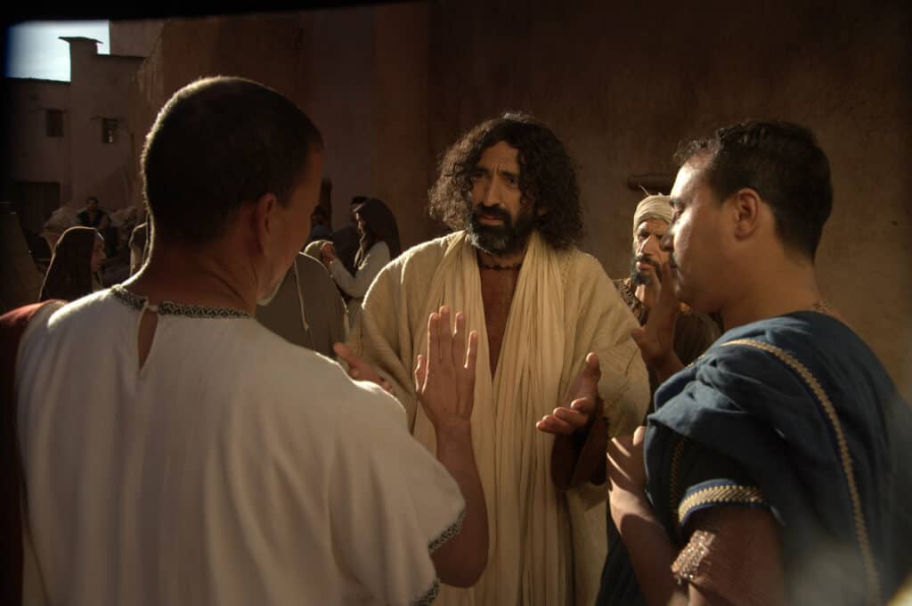 Jesus talking to men about the sin that will not be forgiven, as told in the three Gospels.