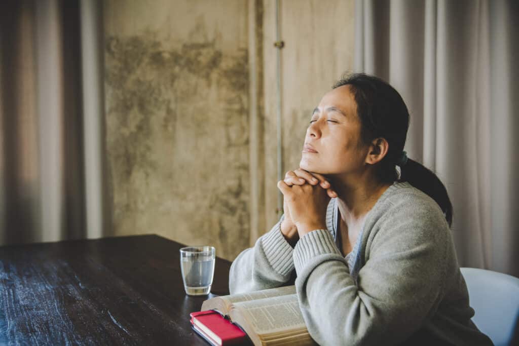 Women praying after Bible study, to ask for help to grow in Christ.