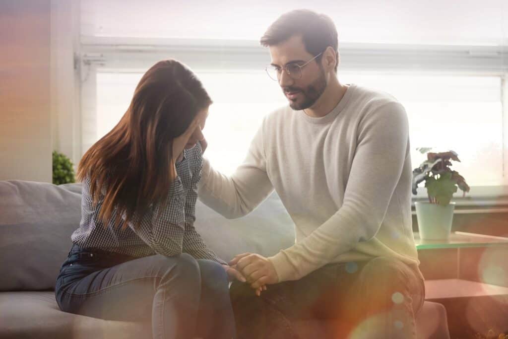 Couple Forgiving A couple struggling with the emotions that come from having to forgive each other for past wrongs.