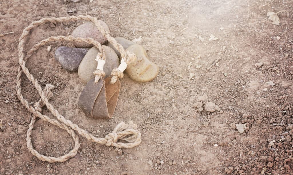 An ancient style sling sitting on the ground like the one used by David on Goliath in the Bible.